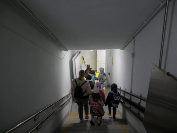 Children enter the bunker at the first underground school in Ukraine