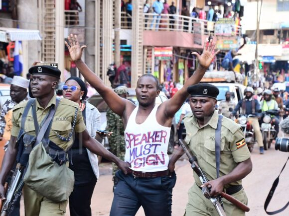 Police in Uganda detain youth protestors during their march through Kampala