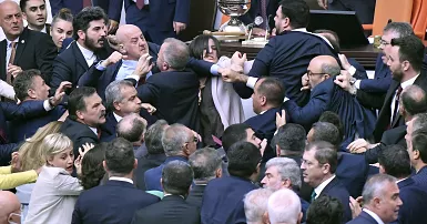 In Turkey, lawmakers engage in a physical altercation during a parliamentary debate regarding a colleague who is currently incarcerated. Blood is shed