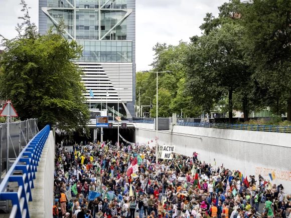 Protesters against climate change block a Dutch roadway as police strike