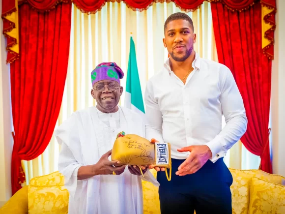 Anthony Joshua Signs a Glove for the President of Nigeria