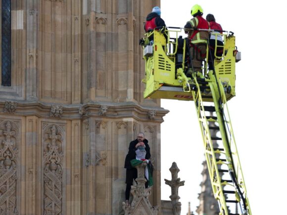 A man was arrested at a protest in London after scaling Big Ben while holding a Palestinian flag