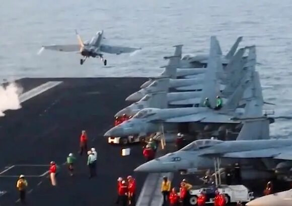 An F/A-18 jet fails to land on the USS Truman and crashes into the Red Sea
