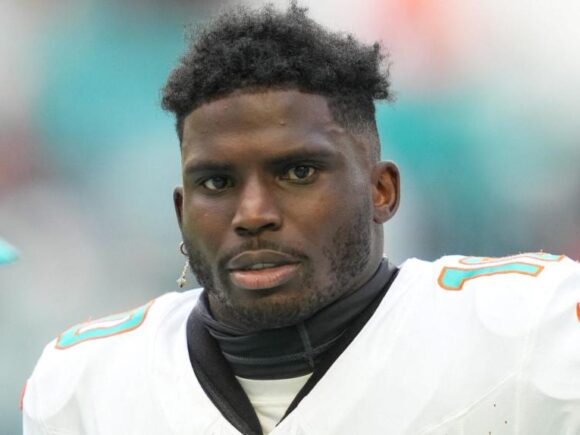 NFL player Tyreek Hill was spotted at the pool with an unidentified woman during a contentious divorce dispute