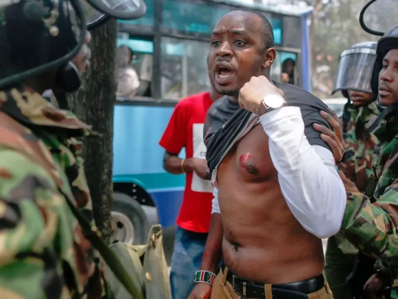Mwangi, a rights activist, is arrested by Kenyan authorities for his involvement in fatal protests