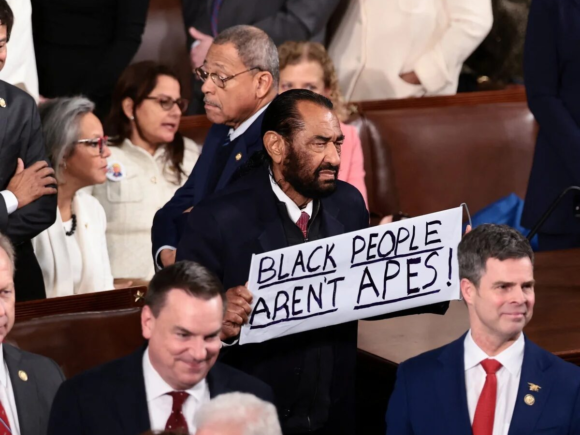 Al Green was ejected from the House during Trump’s State of the Union address because he held up a sign that read, ‘Black People Aren’t Apes.’