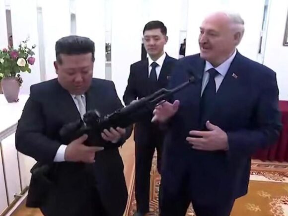 President Lukashenko of Belarus presents a rifle to Kim of North Korea as both nations formalize a friendship treaty